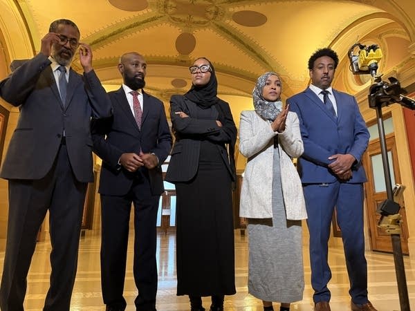 Five lawmakers stand for a press conference