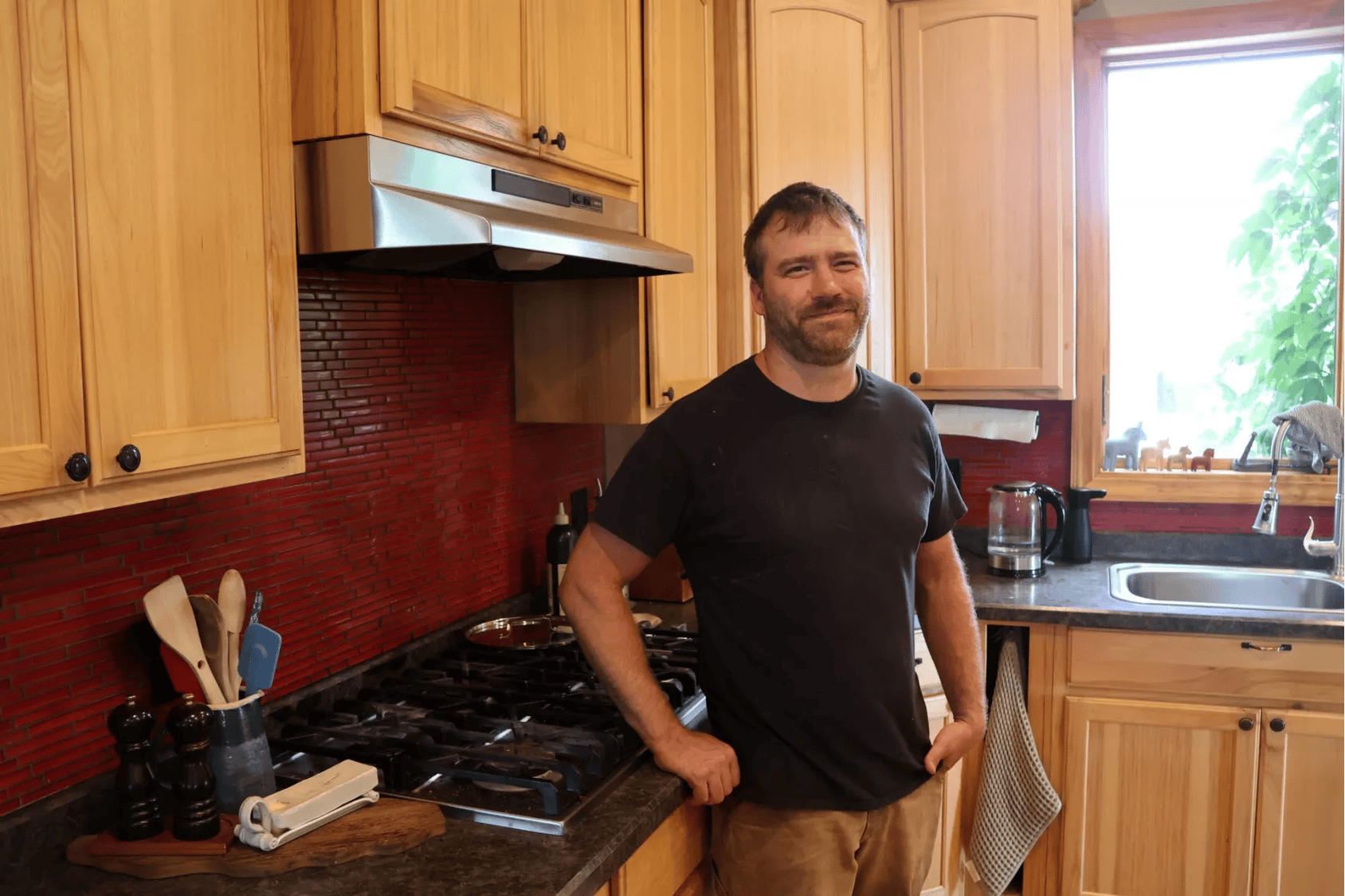 A man stands in his kitchen