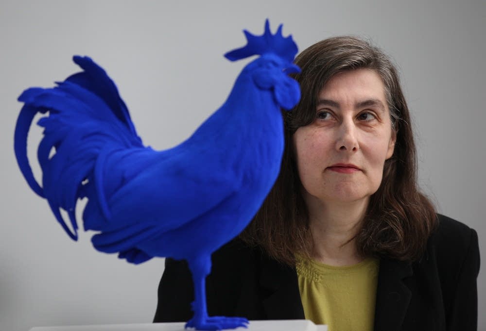 Katharina Fritsch stands with a model of 'Hahn'