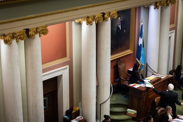 A clerk hands Demuth papers
