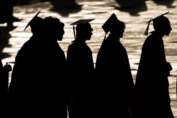 college grads in silhouette