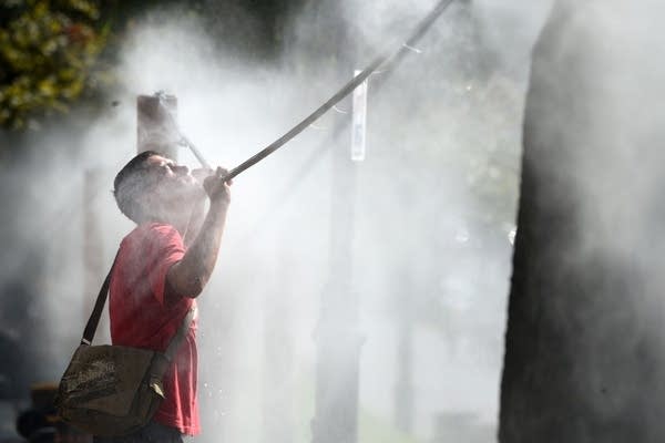 A man cools off with water spray.