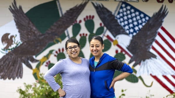 Two people pose for a portrait