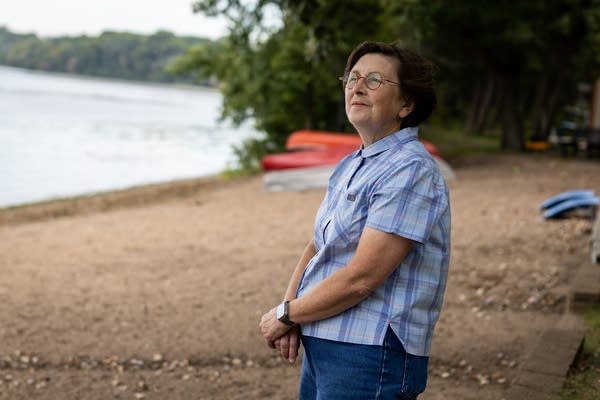 A woman stands on a beach