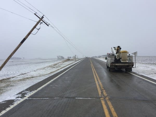 Damaged power poles are seen along a southern Minnesota highway