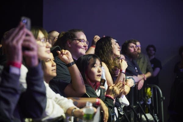Music fans watching a band performing onstage