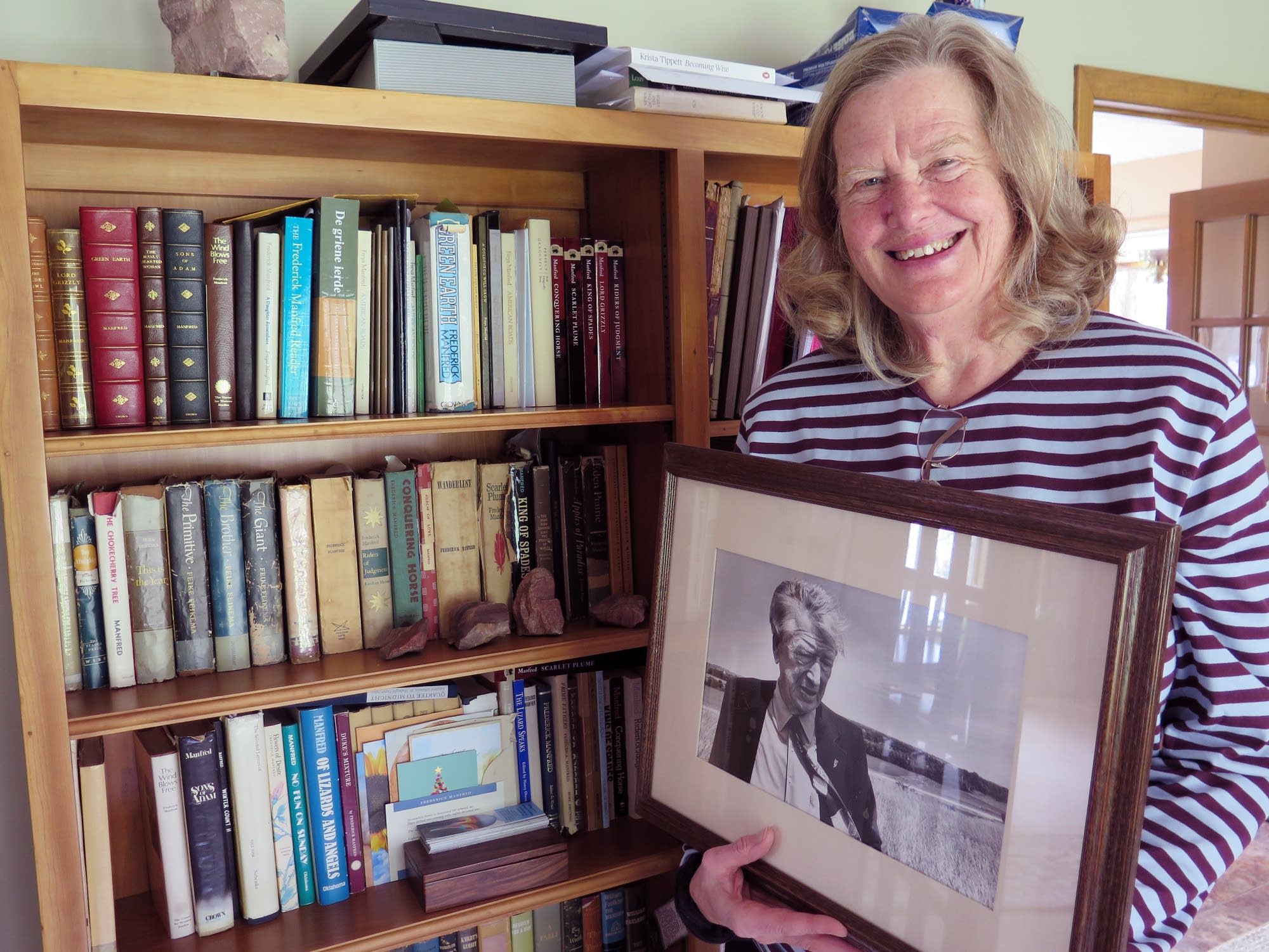 Freya Manfred holds a photo of her father, author Frederick Manfred.