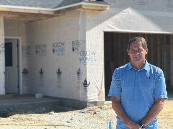 man stands outside of home