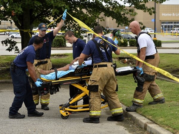 Paramedics offer medical attention after a shooting at a Walmart store.
