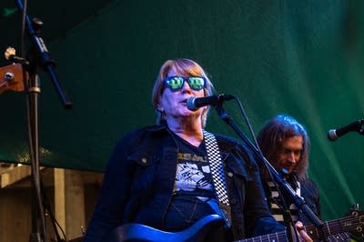 a rock band performing on an outdoor stage
