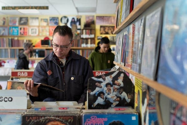 Vinyl enthusiasts look through used records at Hymie's Vintage Records in Minneapolis.