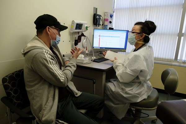 A health care professional performs check ups on patients.