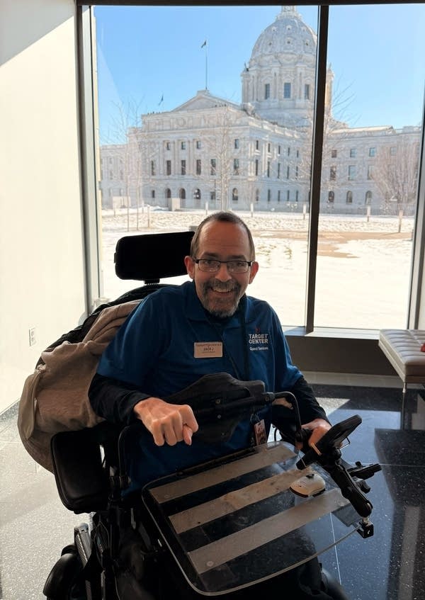 Man poses for portrait with senate building behind him