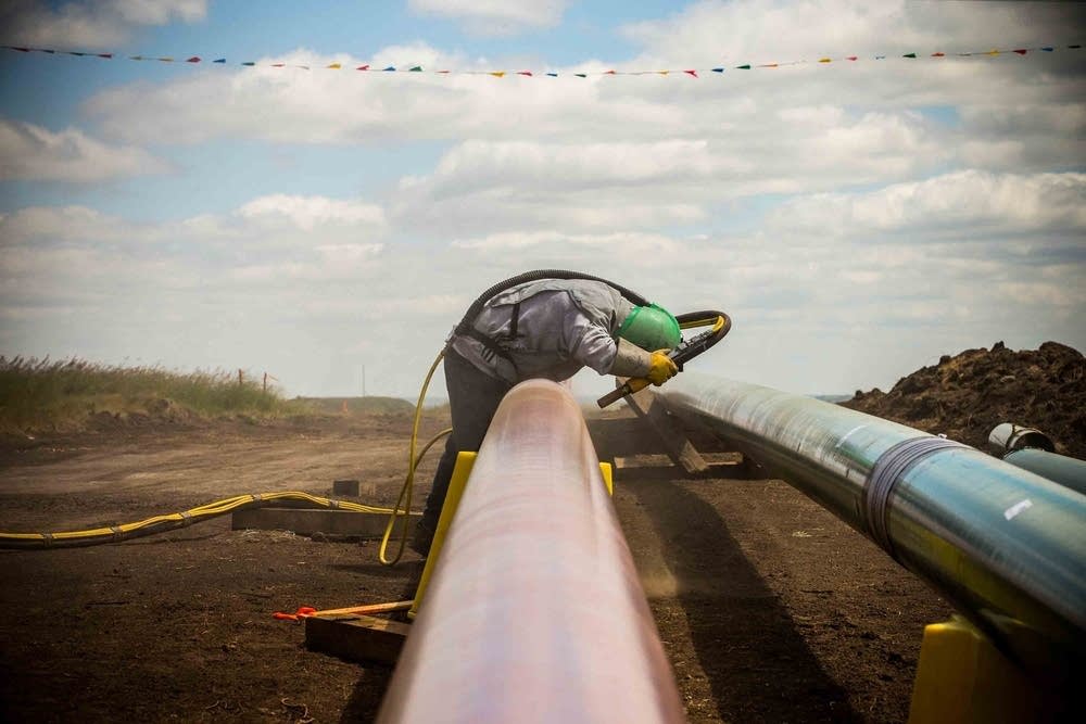 A pipe-laying construction worker