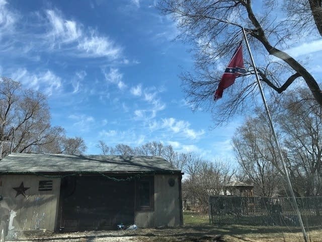 A Confederate flag flies outside a building in Clarence, Ill.