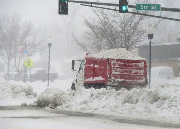 A truck drives in Marshall, Minn., which received about 7 inches of snow.