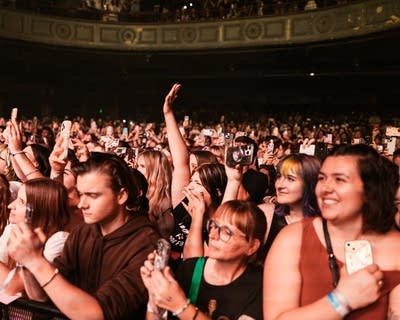 a crowd cheering at a concert
