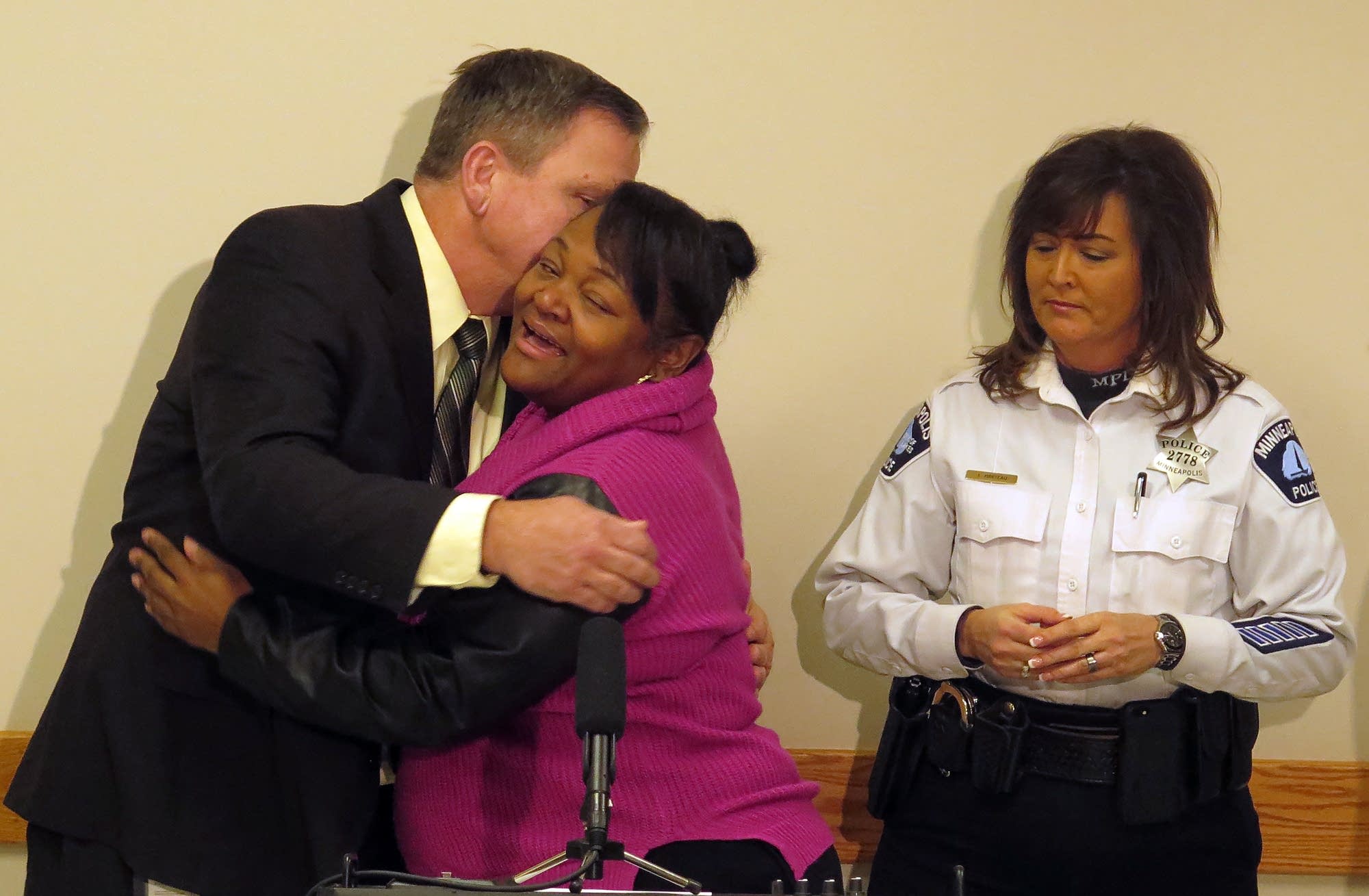 Sa'Lesha Beeks, daughter of Birdell Beeks, embraces Sgt. Chris Thomsen.