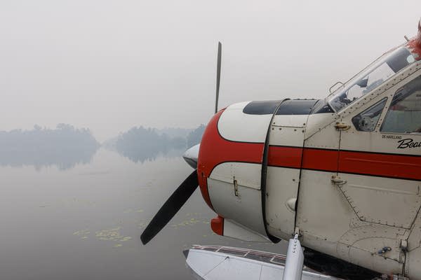 the front of a floatplane on a lake
