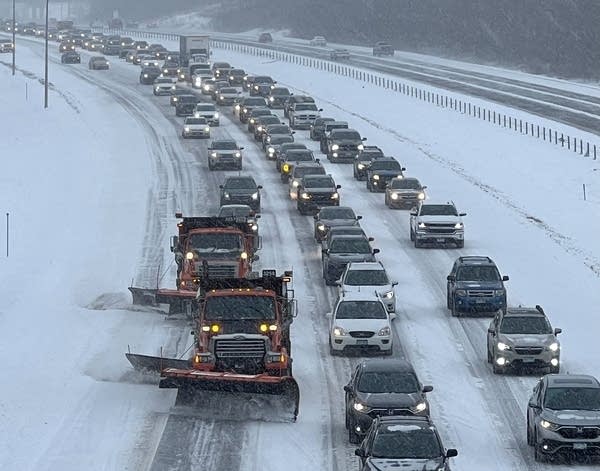 Cars and snowplows on a highway