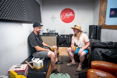 Two musicians relax backstage