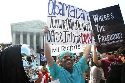 Anti-ACA protesters wear masks