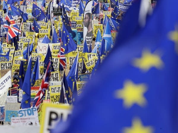 Demonstrators carry posters and flags during an anti-Brexit march