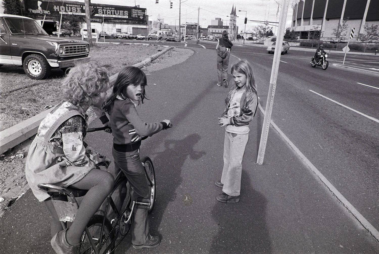 Three girls play on W. 7th Street, near the St. Paul Civic Center.