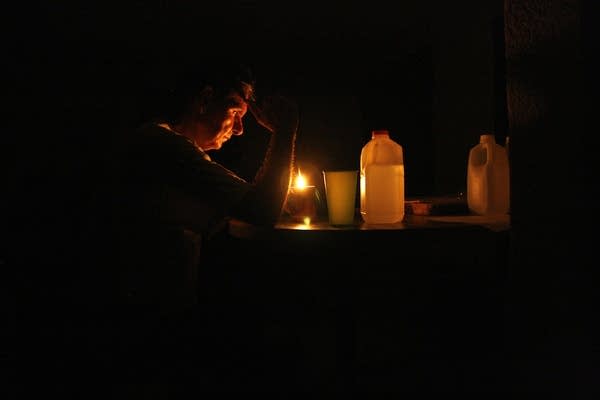 Venezuelans sleep outside their homes due to the fourth mega blackout that left 23 states of the country without power. (Photo by Humberto Matheus/NurPhoto via Getty Images)
