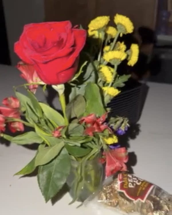 A vase with flowers and chocolate