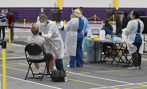 A person sits in a chair while being tested for COVID-19.