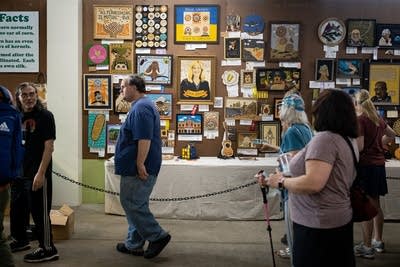 People walk past crop art