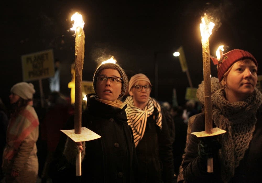 Protesters cary torches