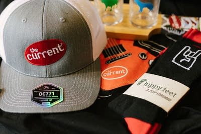 Close up of The Current merch