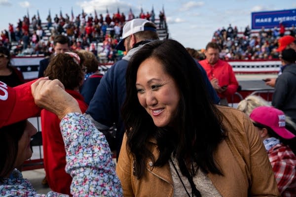 A woman smiles and talks.