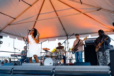 A band performing on an outdoor stage