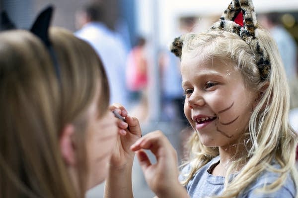 Megan Leschinsky, 7, draws whiskers