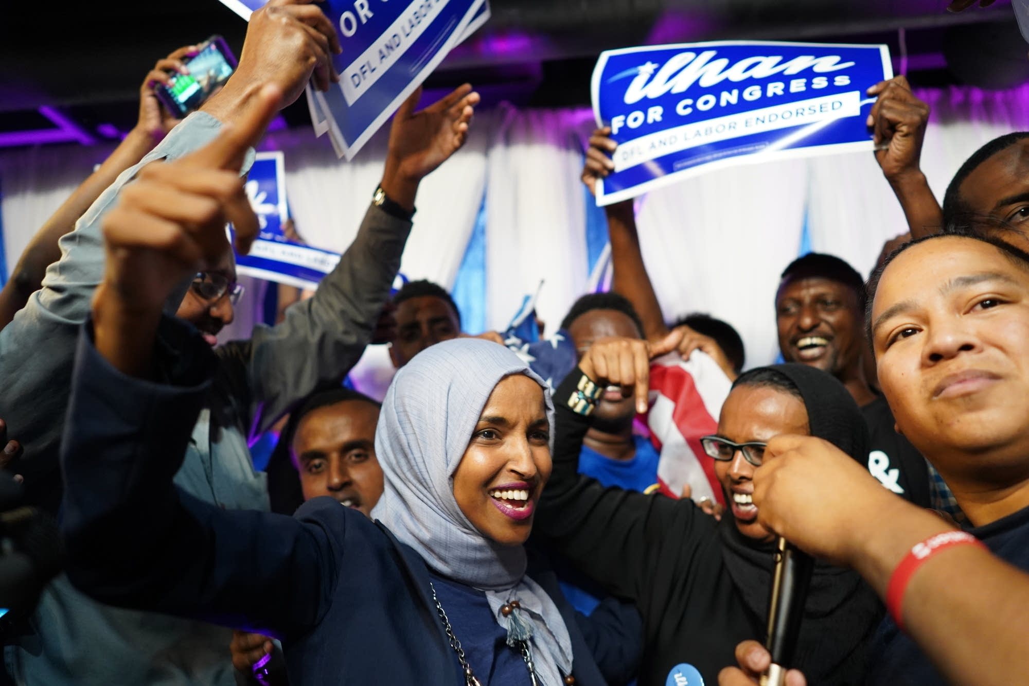 Minnesota Rep. Ilhan Omar, center, celebrates with her supporters.