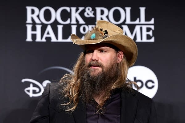 A man in a cowboy hat arrives at an awards ceremony