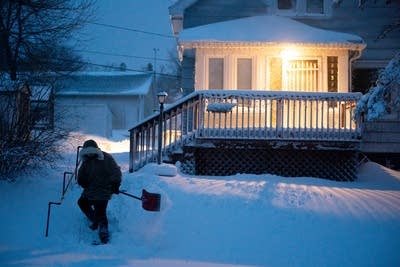 A person shovels snow.