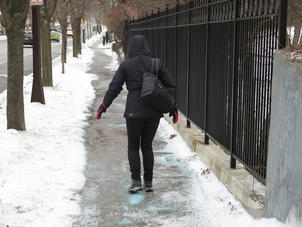 Justyna Sparrow negotiates an icy Ramsey Hill sidewalk.