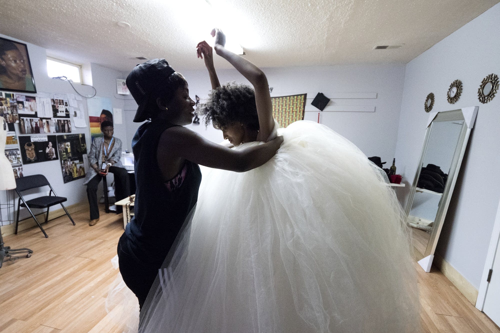 Jacqueline Addison, left, works with model Lydia Negussie during a fitting.