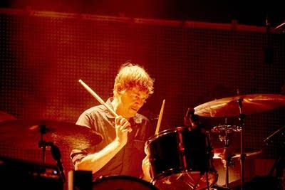 A musician plays drums onstage