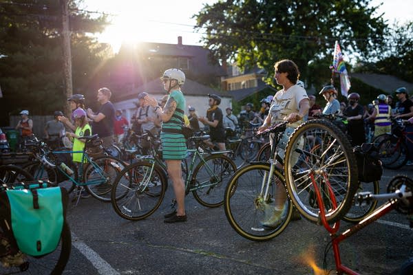 People with bikes gather in a parking lot