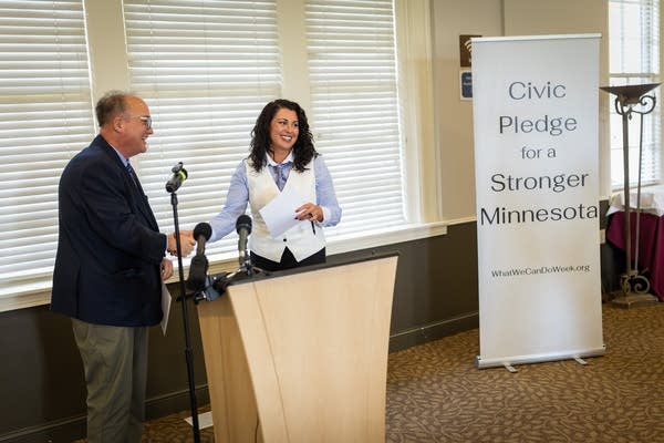 Two people shake hands