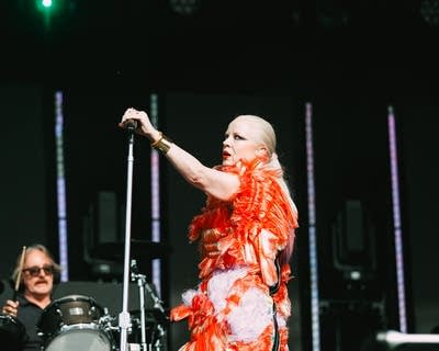Two musicians performing together on a large outdoor stage
