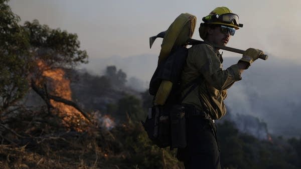 A Cal Fire firefighter battles the Sandy Fire on Monday in Simi Valley, California.