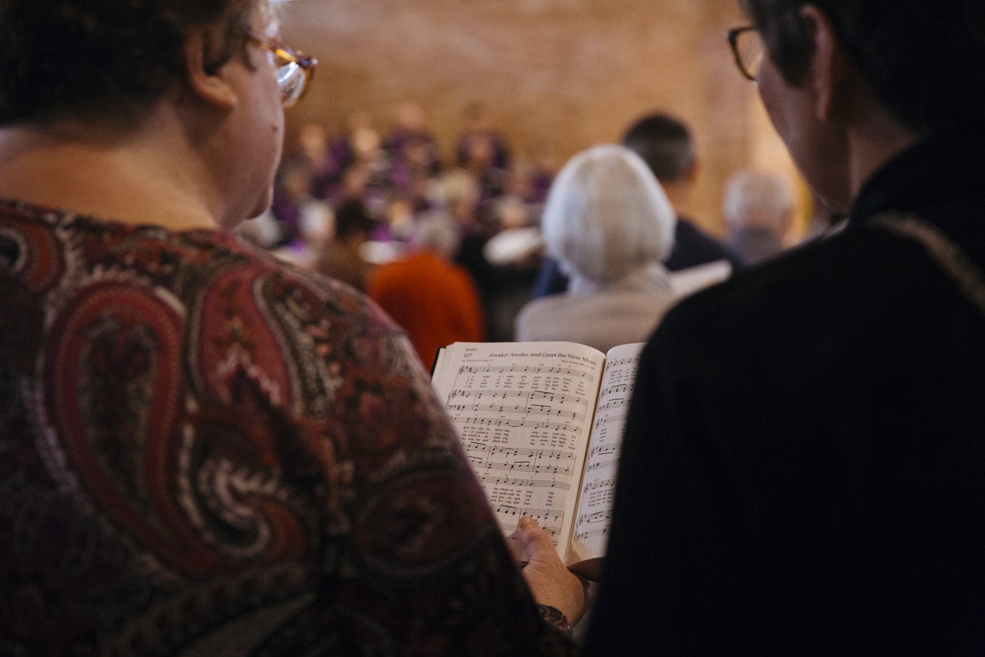 Parishioners sing from a hymnal at Mayflower church.