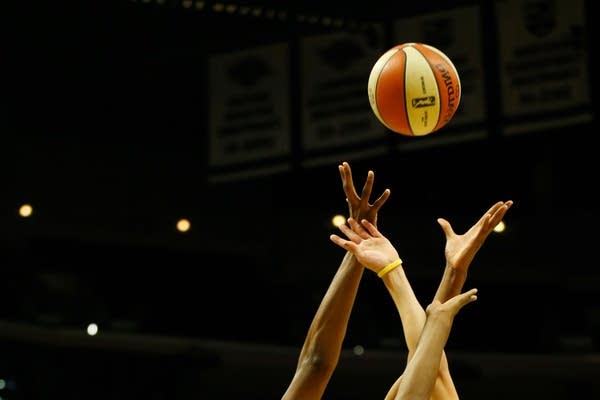 Players for the Los Angeles Sparks and Seattle Storm reach for a rebound during a game at in Los Angeles, California in 2019.