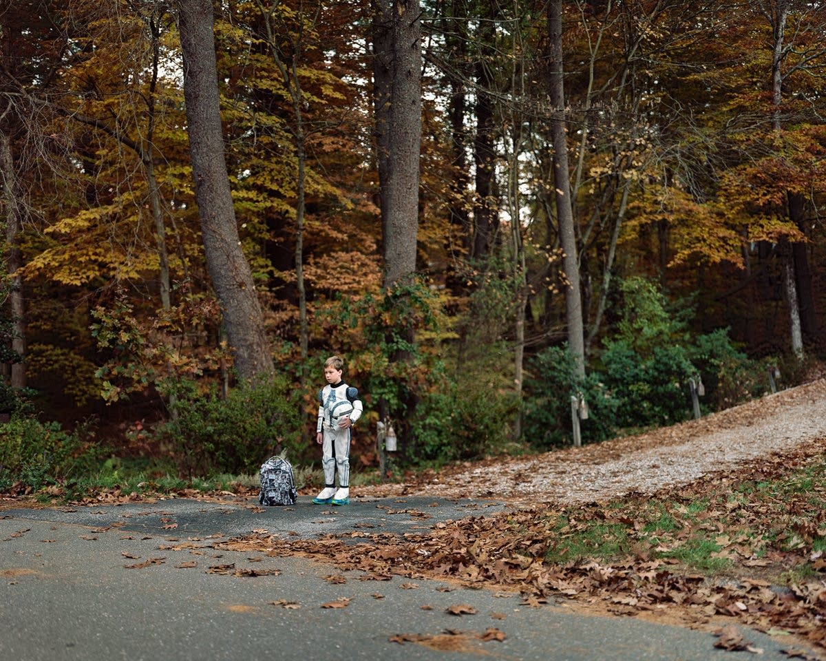 Children wait for their morning bus to school.
